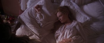 Movie still from “Dangerous Beauty” (1998), directed by Marshall Herskovitz – A woman laying in a bed with a white comforter; Medium shot, Overhead angle