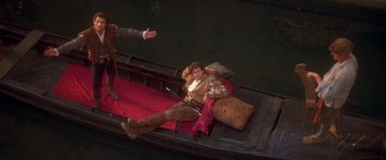 Movie still from “Dangerous Beauty” (1998), directed by Marshall Herskovitz – A man sitting in a boat on the water; Wide shot, High angle