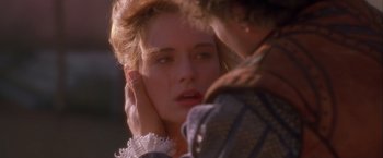 Movie still from “Dangerous Beauty” (1998), directed by Marshall Herskovitz – A woman with a hand on her face and a man with a hand on her face; Close Up shot, Over the shoulder angle