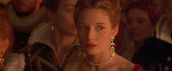 Movie still from “Dangerous Beauty” (1998), directed by Marshall Herskovitz – A person wearing a necklace and earrings; Close Up shot, Over the shoulder angle