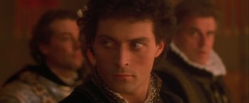 Movie still from “Dangerous Beauty” (1998), directed by Marshall Herskovitz – A person wearing a black jacket; Close Up shot, High angle