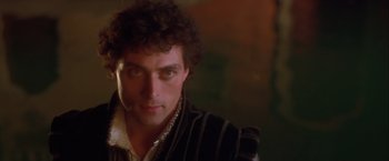 Movie still from “Dangerous Beauty” (1998), directed by Marshall Herskovitz – A person wearing a black and white striped shirt; Close Up shot, Over the shoulder angle