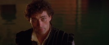 Movie still from “Dangerous Beauty” (1998), directed by Marshall Herskovitz – A person wearing a black and white striped vest; Close Up shot, Over the shoulder angle