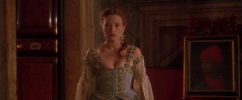 Movie still from “Dangerous Beauty” (1998), directed by Marshall Herskovitz – A woman in a blue and gold dress; Medium shot, Over the shoulder angle