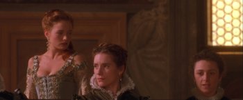 Movie still from “Dangerous Beauty” (1998), directed by Marshall Herskovitz – A woman in a green and white dress looking at the camera; Close Up shot, Over the shoulder angle