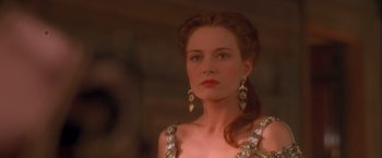 Movie still from “Dangerous Beauty” (1998), directed by Marshall Herskovitz – A woman with red hair wearing a dress and earrings; Close Up shot, Over the shoulder angle
