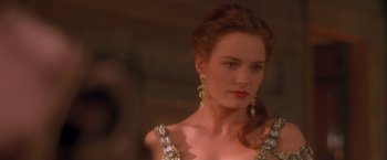 Movie still from “Dangerous Beauty” (1998), directed by Marshall Herskovitz – A woman in a dress with long earrings; Close Up shot, Over the shoulder angle