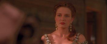 Movie still from “Dangerous Beauty” (1998), directed by Marshall Herskovitz – A woman with long red hair wearing a dress and earrings; Close Up shot, Over the shoulder angle
