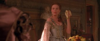 Movie still from “Dangerous Beauty” (1998), directed by Marshall Herskovitz – A beautiful woman holding a banana in her hand; Close Up shot, Over the shoulder angle