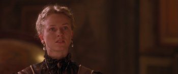Movie still from “Dangerous Beauty” (1998), directed by Marshall Herskovitz – A young woman with blonde ringlet hair wearing a necklace; Close Up shot, Low angle