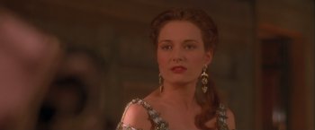 Movie still from “Dangerous Beauty” (1998), directed by Marshall Herskovitz – A woman with long red hair wearing a white dress; Close Up shot, Over the shoulder angle