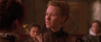 Movie still from “Dangerous Beauty” (1998), directed by Marshall Herskovitz – A woman in a brown dress looking to her left; Close Up shot, Over the shoulder angle