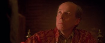 Movie still from “Dangerous Beauty” (1998), directed by Marshall Herskovitz – An older bald man wearing a red and gold jacket; Close Up shot, Low angle