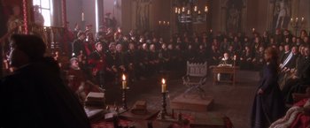 Movie still from “Dangerous Beauty” (1998), directed by Marshall Herskovitz – A group of people sitting in front of candles in a room; Wide shot, High angle