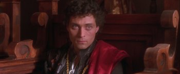 Movie still from “Dangerous Beauty” (1998), directed by Marshall Herskovitz – A person wearing a red cape; Close Up shot, High angle