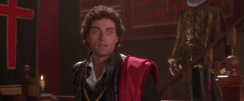 Movie still from “Dangerous Beauty” (1998), directed by Marshall Herskovitz – A person wearing a suit and tie; Close Up shot, Over the shoulder angle