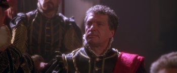 Movie still from “Dangerous Beauty” (1998), directed by Marshall Herskovitz – A person wearing a suit and tie; Close Up shot, Over the shoulder angle