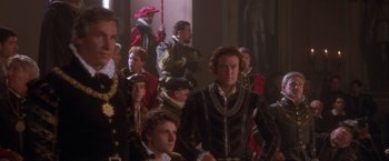 Movie still from “Dangerous Beauty” (1998), directed by Marshall Herskovitz – A group of people in medieval garb standing in a room; Medium shot, Over the shoulder angle