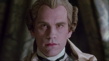 Movie still from “Dangerous Liaisons” (1988), directed by Stephen Frears – A person wearing a suit and tie; Close Up shot, Low angle