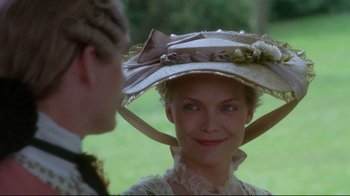 Movie still from “Dangerous Liaisons” (1988), directed by Stephen Frears – A woman wearing a hat with a bow around her head; Close Up shot, Over the shoulder angle