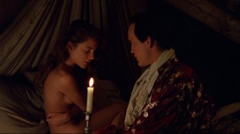 Movie still from “Dangerous Liaisons” (1988), directed by Stephen Frears – A man and a woman sitting in front of a lit candle; Medium shot, High angle