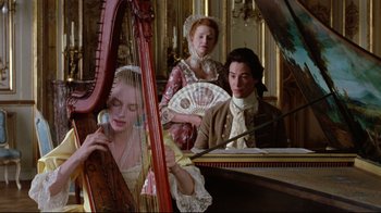 Movie still from “Dangerous Liaisons” (1988), directed by Stephen Frears – A group of people in period dress playing musical instruments in a room; Medium shot, High angle