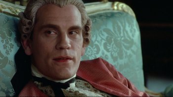 Movie still from “Dangerous Liaisons” (1988), directed by Stephen Frears – A person sitting on a chair; Close Up shot, Low angle