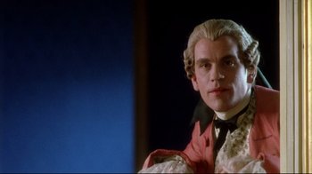 Movie still from “Dangerous Liaisons” (1988), directed by Stephen Frears – A person wearing a suit and tie; Close Up shot, Low angle