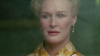 Movie still from “Dangerous Liaisons” (1988), directed by Stephen Frears – An older woman with blonde hair wearing a yellow shirt; Close Up shot, Over the shoulder angle