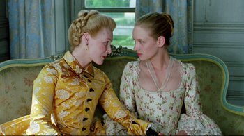Movie still from “Dangerous Liaisons” (1988), directed by Stephen Frears – Two women sitting on a couch talking to each other; Medium shot, Over the shoulder angle