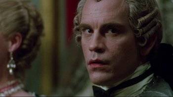 Movie still from “Dangerous Liaisons” (1988), directed by Stephen Frears – A man that is wearing a suit and a bow tie; Close Up shot, Over the shoulder angle
