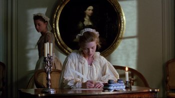 Movie still from “Dangerous Liaisons” (1988), directed by Stephen Frears – A woman writing on a paper at a table; Medium shot, High angle