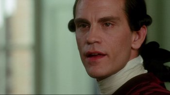 Movie still from “Dangerous Liaisons” (1988), directed by Stephen Frears – A man that is wearing a neck brace; Close Up shot, Over the shoulder angle