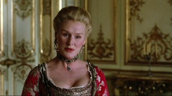 Movie still from “Dangerous Liaisons” (1988), directed by Stephen Frears – A woman in a red and gold dress; Close Up shot, Low angle