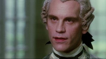 Movie still from “Dangerous Liaisons” (1988), directed by Stephen Frears – A person wearing a suit and tie; Close Up shot, Over the shoulder angle