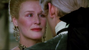 Movie still from “Dangerous Liaisons” (1988), directed by Stephen Frears – An older woman looking into a mirror while a younger man looks on; Close Up shot, Over the shoulder angle