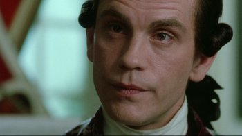 Movie still from “Dangerous Liaisons” (1988), directed by Stephen Frears – A man that is looking into the camera; Close Up shot, Over the shoulder angle