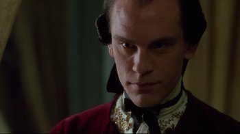 Movie still from “Dangerous Liaisons” (1988), directed by Stephen Frears – A person wearing a suit and tie; Close Up shot, Over the shoulder angle