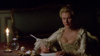 Movie still from “Dangerous Liaisons” (1988), directed by Stephen Frears – A woman in a dress writing with a feather pen; Medium shot, Low angle