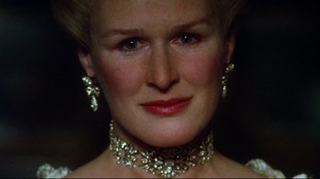 Movie still from “Dangerous Liaisons” (1988), directed by Stephen Frears – A person wearing a necklace and earrings; Close Up shot, Over the shoulder angle