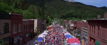 Movie still from “Dante's Peak” (1997), directed by Roger Donaldson – An aerial view of a crowd of people walking down a street; Extreme Wide shot, High angle