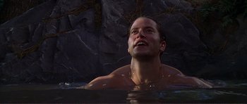 Movie still from “Dante's Peak” (1997), directed by Roger Donaldson – A man in a pool of water looking up at the sky; Close Up shot, Low angle