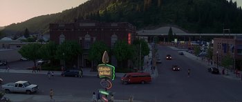 Movie still from “Dante's Peak” (1997), directed by Roger Donaldson – A view of a city street with people walking and cars driving on the road; Extreme Wide shot, High angle