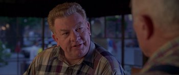 Movie still from “Dante's Peak” (1997), directed by Roger Donaldson – A person wearing a plaid shirt; Close Up shot, Over the shoulder angle