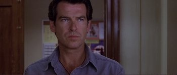 Movie still from “Dante's Peak” (1997), directed by Roger Donaldson – A person wearing a gray shirt; Close Up shot, Over the shoulder angle