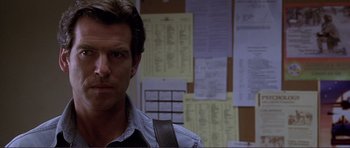 Movie still from “Dante's Peak” (1997), directed by Roger Donaldson – A man standing in front of a wall of papers; Close Up shot, Over the shoulder angle