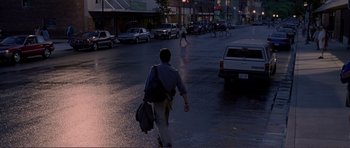 Movie still from “Dante's Peak” (1997), directed by Roger Donaldson – A man walking down a street at night; Wide shot, Over the shoulder angle