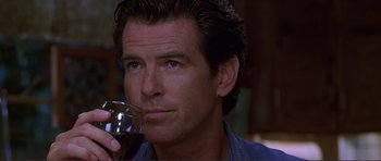Movie still from “Dante's Peak” (1997), directed by Roger Donaldson – A person holding a glass of red wine; Close Up shot, Over the shoulder angle
