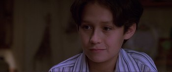 Movie still from “Dante's Peak” (1997), directed by Roger Donaldson – A person wearing a striped shirt; Close Up shot, Low angle