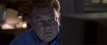 Movie still from “Dante's Peak” (1997), directed by Roger Donaldson – A man's face in the dark; Close Up shot, Low angle